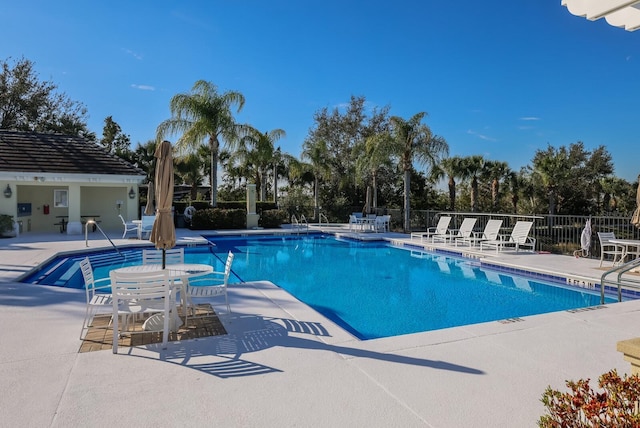 pool featuring fence and a patio