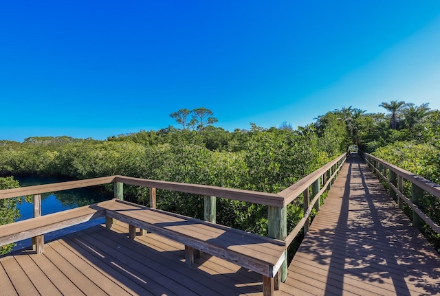 deck featuring a water view and a forest view