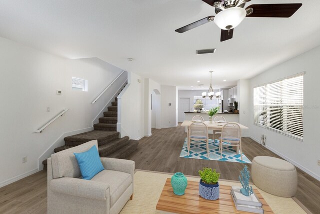 5526 River Sound Ter, Bradenton, FL 34208 - living area with a chandelier, wood finished floors, stairs, ceiling fan, and baseboards