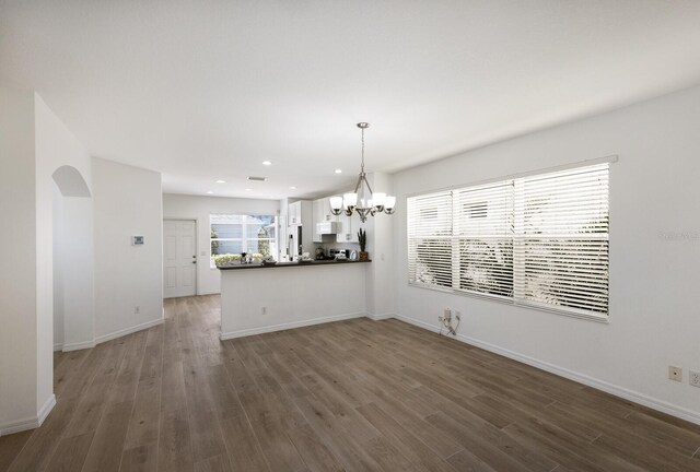 5526 River Sound Ter, Bradenton, FL 34208 - unfurnished dining area with dark wood-style floors, a chandelier, recessed lighting, and baseboards