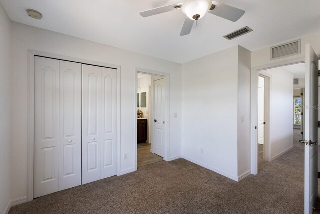 5526 River Sound Ter, Bradenton, FL 34208 - unfurnished bedroom featuring carpet, a closet, baseboards, and ceiling fan