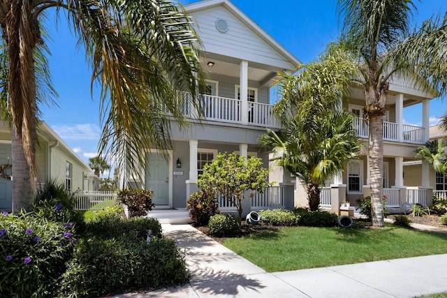 5526 River Sound Ter, Bradenton, FL 34208 - view of front of home featuring a porch, a front lawn, and a balcony