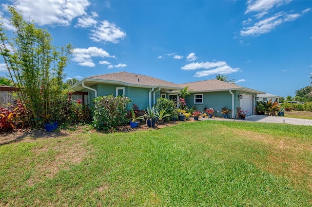 ranch-style house with an attached garage, stucco siding, a front yard, and concrete driveway