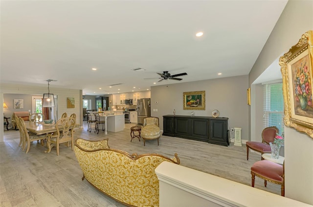 living room featuring recessed lighting, ceiling fan, light wood finished floors, and visible vents