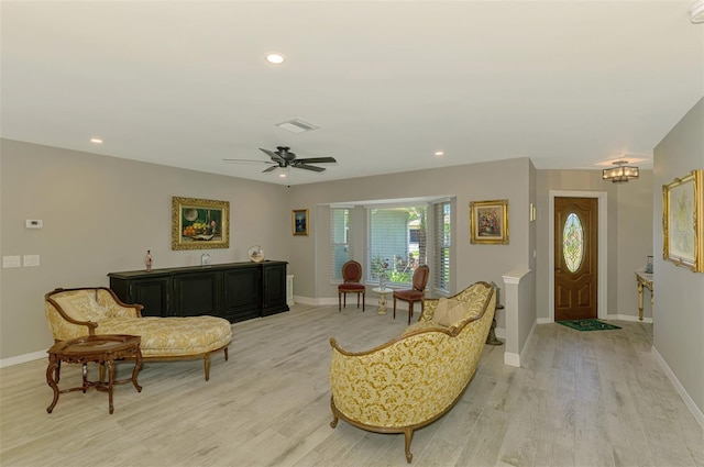 living room featuring recessed lighting, baseboards, and light wood-style floors