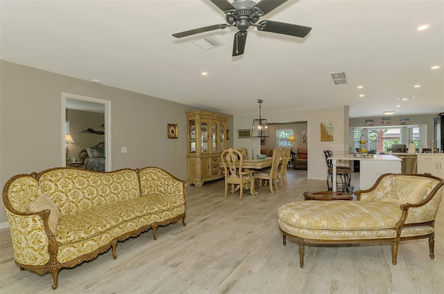living area with recessed lighting, a ceiling fan, light wood finished floors, and visible vents