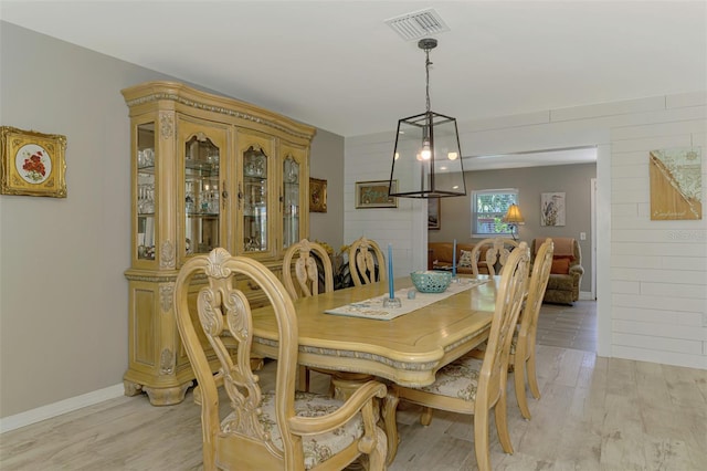 dining room with light wood-style floors and visible vents