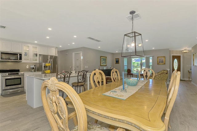 dining room with visible vents, recessed lighting, and light wood-type flooring