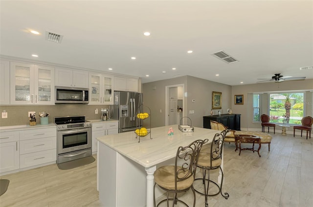 kitchen featuring stainless steel appliances, visible vents, and light wood-style flooring