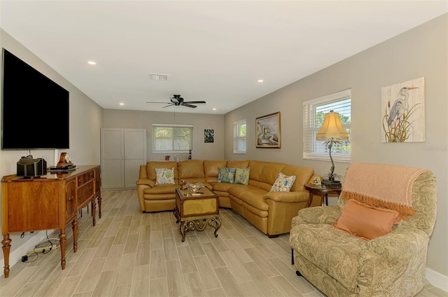 living area featuring visible vents, a ceiling fan, light wood finished floors, and recessed lighting