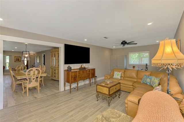 living area featuring a ceiling fan, baseboards, visible vents, and recessed lighting