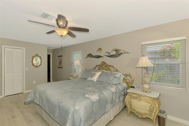 bedroom with a ceiling fan, baseboards, visible vents, and light wood-style flooring