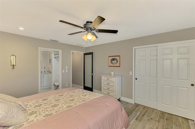 bedroom featuring visible vents, a closet, baseboards, light wood-type flooring, and a ceiling fan