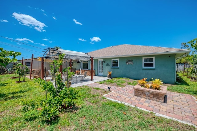 back of house with fence, a pergola, stucco siding, a patio area, and a yard