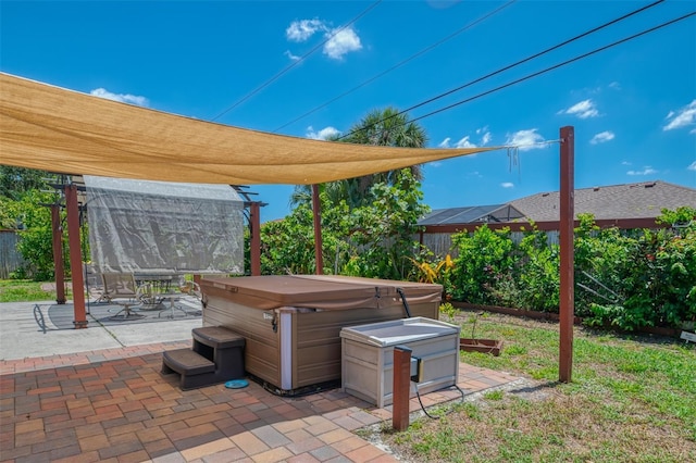 view of patio featuring a fenced backyard and a hot tub