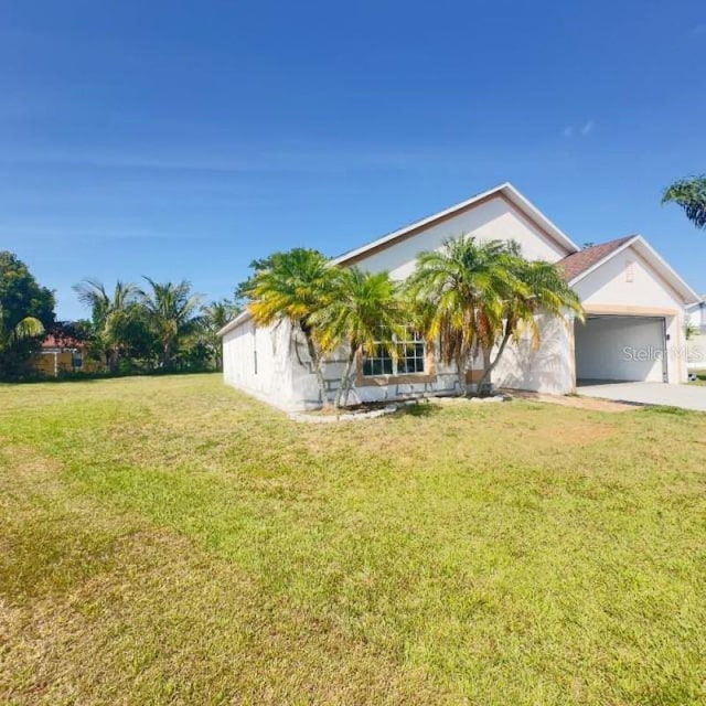 view of front of property with driveway, a front yard, and a garage