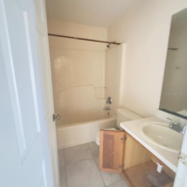 bathroom featuring toilet, tile patterned floors, shower / tub combination, and vanity