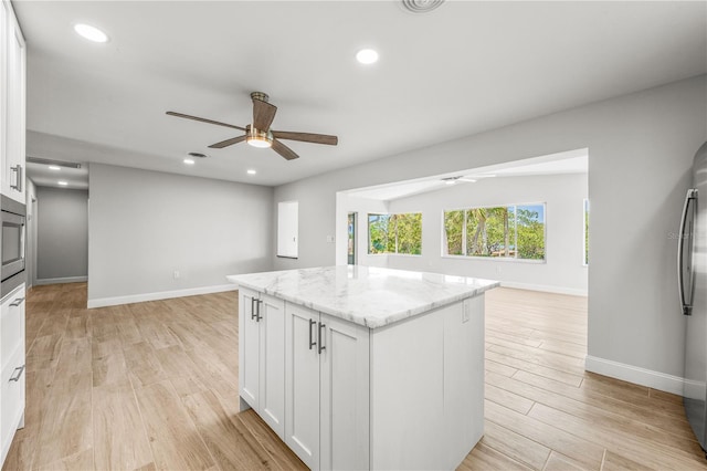 1680 Lemon Bay Dr, Venice, FL 34293 - kitchen featuring ceiling fan, open floor plan, baseboards, white cabinetry, and recessed lighting