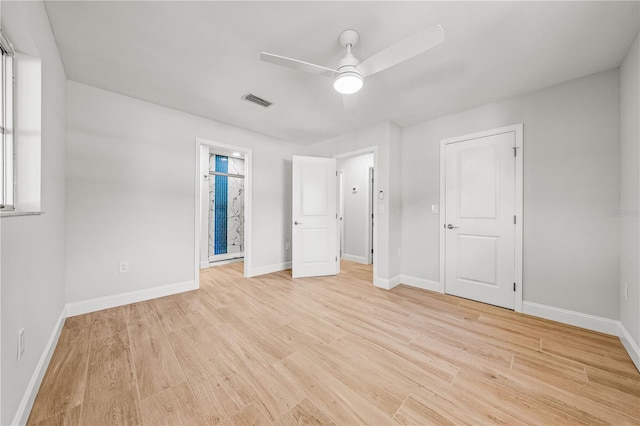 1680 Lemon Bay Dr, Venice, FL 34293 - unfurnished bedroom with light wood-style flooring, baseboards, a ceiling fan, and connected bathroom