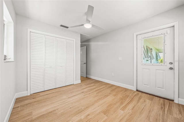 1680 Lemon Bay Dr, Venice, FL 34293 - unfurnished bedroom featuring wood finished floors, baseboards, a closet, and ceiling fan