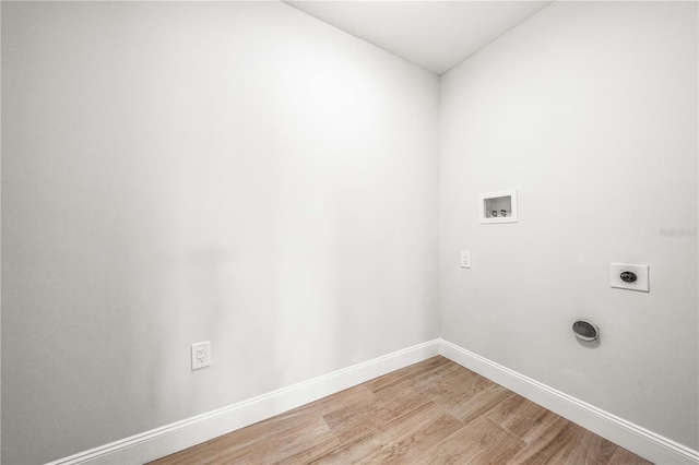 1680 Lemon Bay Dr, Venice, FL 34293 - washroom with hookup for an electric dryer, washer hookup, light wood-type flooring, and baseboards