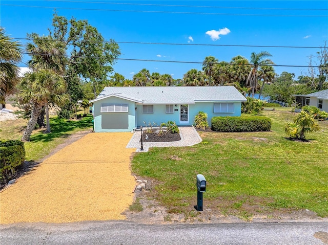 1680 Lemon Bay Dr, Venice, FL 34293 - ranch-style home with a front yard, driveway, and stucco siding