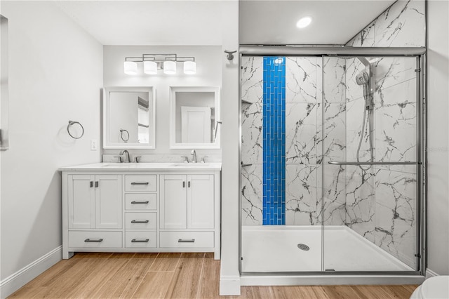 1680 Lemon Bay Dr, Venice, FL 34293 - full bath with a marble finish shower, wood finished floors, double vanity, and baseboards