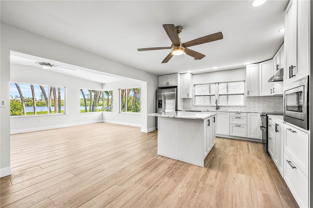 1680 Lemon Bay Dr, Venice, FL 34293 - kitchen featuring a ceiling fan, appliances with stainless steel finishes, baseboards, under cabinet range hood, and recessed lighting