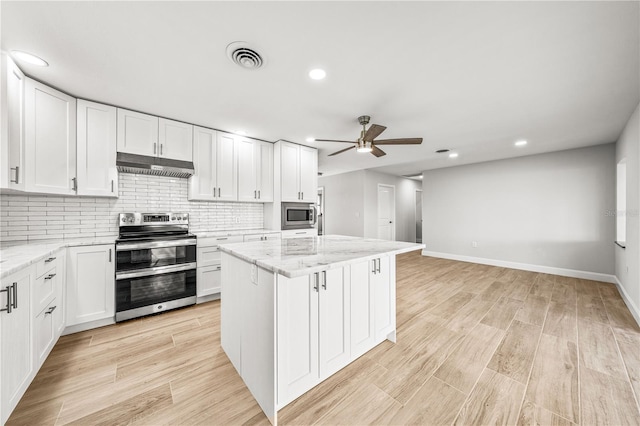 1680 Lemon Bay Dr, Venice, FL 34293 - kitchen featuring stainless steel appliances, under cabinet range hood, ceiling fan, white cabinets, and recessed lighting