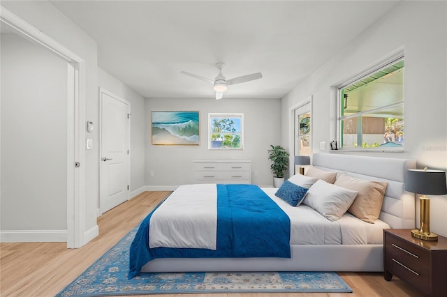 1680 Lemon Bay Dr, Venice, FL 34293 - bedroom with light wood finished floors, baseboards, and ceiling fan