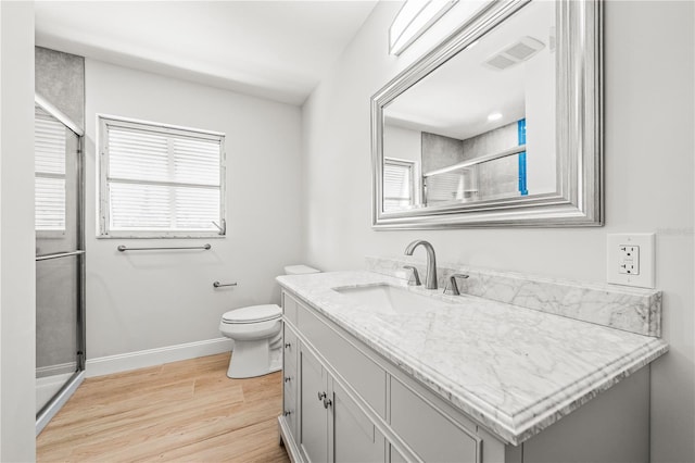 1680 Lemon Bay Dr, Venice, FL 34293 - full bath with a shower stall, wood finished floors, baseboards, vanity, and toilet