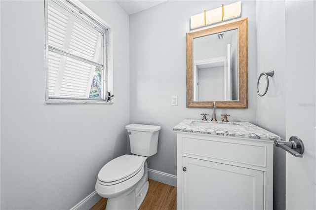 1680 Lemon Bay Dr, Venice, FL 34293 - half bath featuring baseboards, wood finished floors, vanity, and toilet