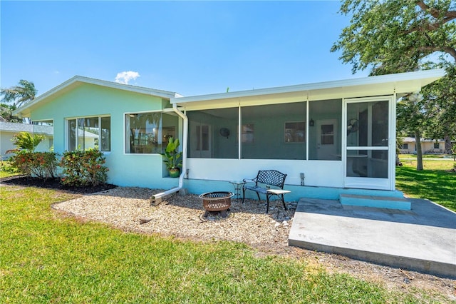 1680 Lemon Bay Dr, Venice, FL 34293 - back of property with a sunroom, a lawn, and stucco siding