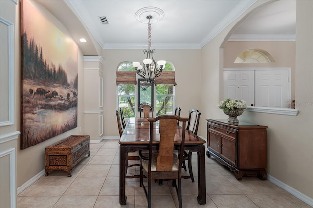 dining space featuring light tile patterned floors, visible vents, ornamental molding, and a notable chandelier