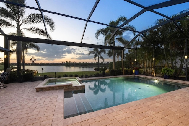 view of pool with a water view, a pool with connected hot tub, a lanai, and a patio