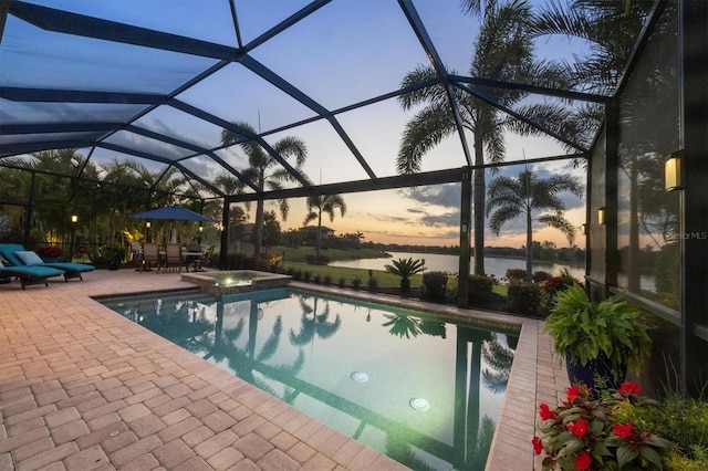 view of pool with a patio, outdoor dining area, a water view, glass enclosure, and a pool with connected hot tub