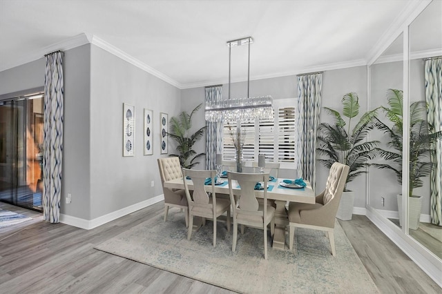 dining room featuring an inviting chandelier, crown molding, and wood finished floors