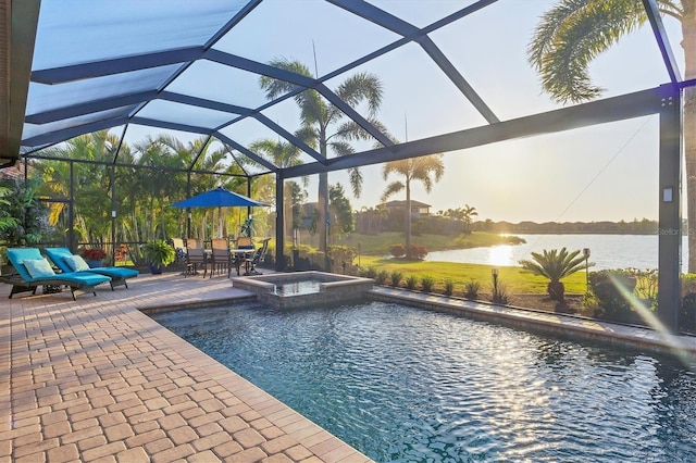 view of pool with a water view, a pool with connected hot tub, a lanai, and a patio area