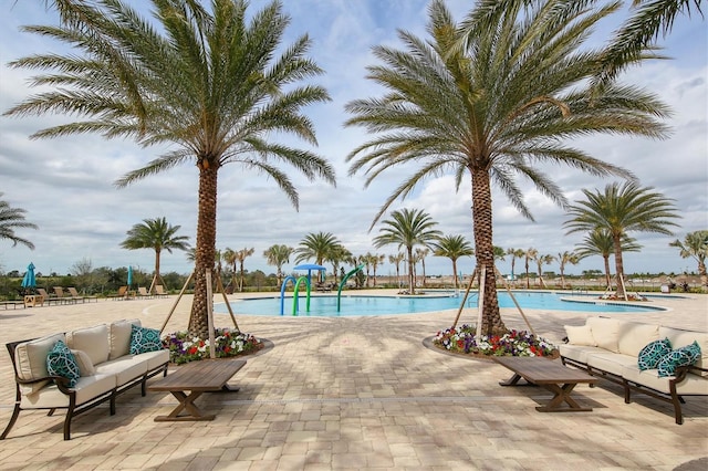 community pool featuring an outdoor living space and a patio area