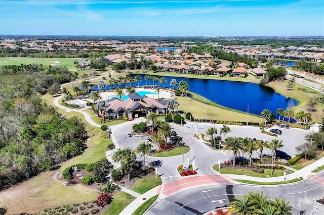 birds eye view of property featuring a water view, view of golf course, and a residential view