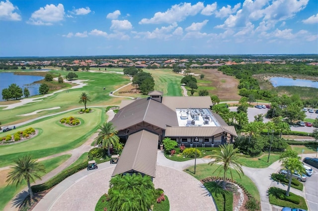 drone / aerial view featuring a water view and golf course view