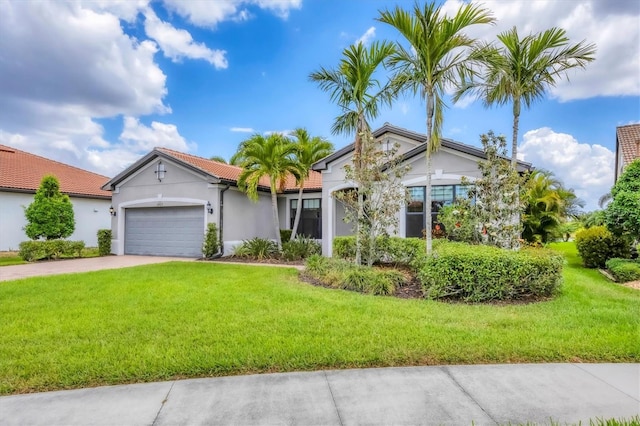 single story home featuring a tile roof, a garage, stucco siding, a front yard, and concrete driveway