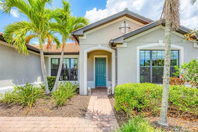 entrance to property with stucco siding