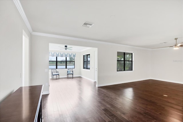 unfurnished living room with dark wood-style floors, ceiling fan, visible vents, and ornamental molding