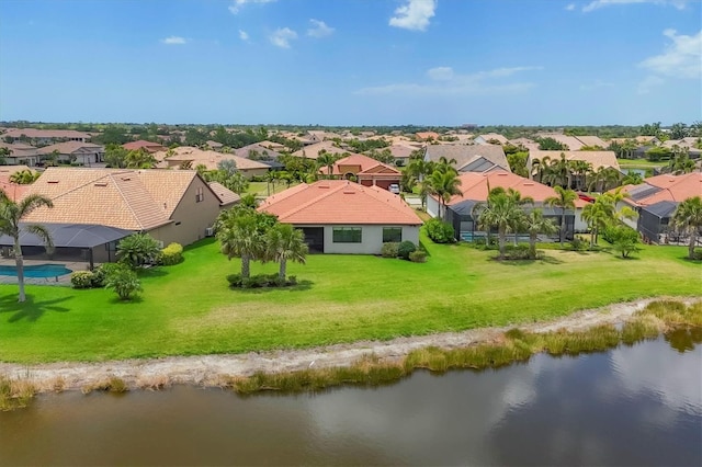 drone / aerial view with a water view and a residential view