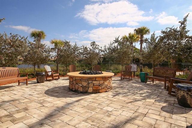 view of patio featuring fence and a fire pit