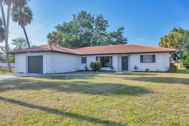 2301 Cass St, Sarasota, FL 34231 - ranch-style home with an attached garage, stucco siding, a tiled roof, and a front yard