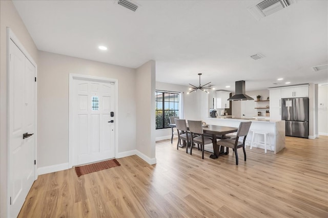 2301 Cass St, Sarasota, FL 34231 - foyer with baseboards, visible vents, and light wood-style flooring