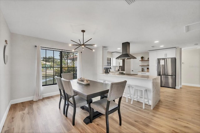 2301 Cass St, Sarasota, FL 34231 - dining space featuring baseboards, recessed lighting, light wood-style floors, and a chandelier