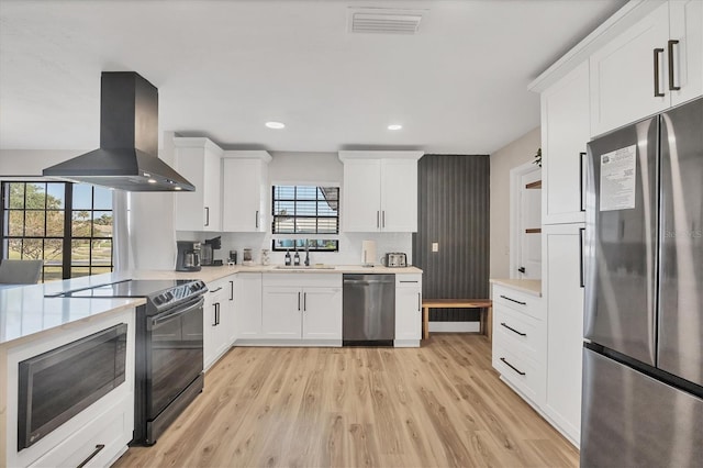 2301 Cass St, Sarasota, FL 34231 - kitchen with a sink, light wood finished floors, light countertops, stainless steel appliances, and range hood